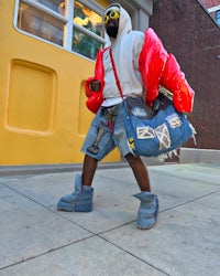 a man walking down the street with a bag